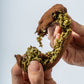 Hands pulling apart truffle revealing filling
