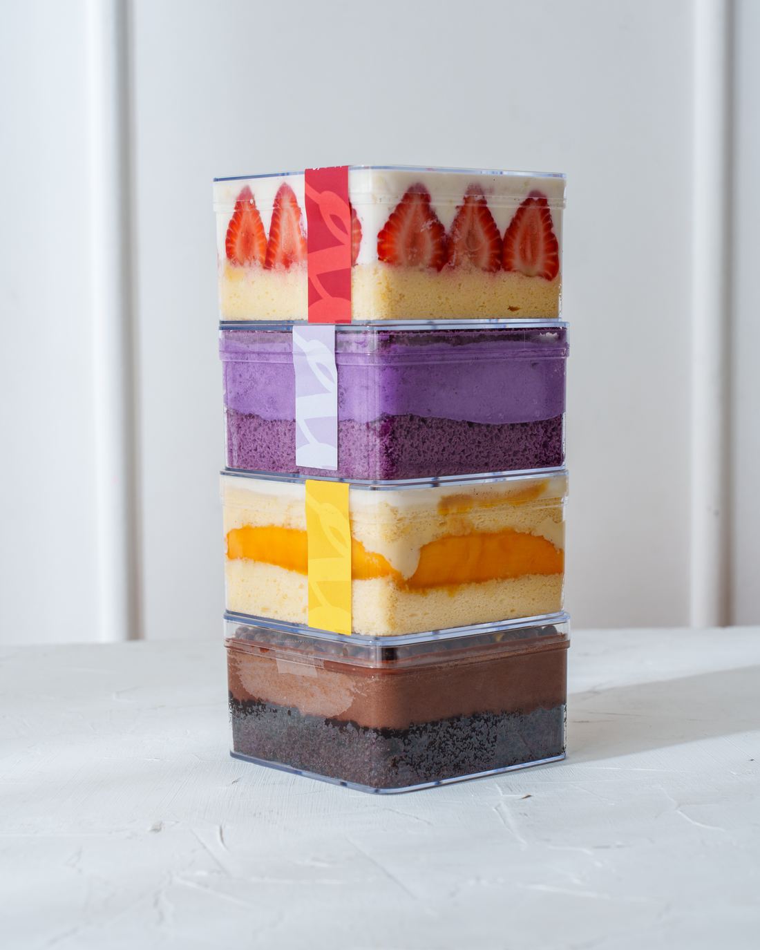 Indulge box cakes — strawberry, ube, mango, and chocolate