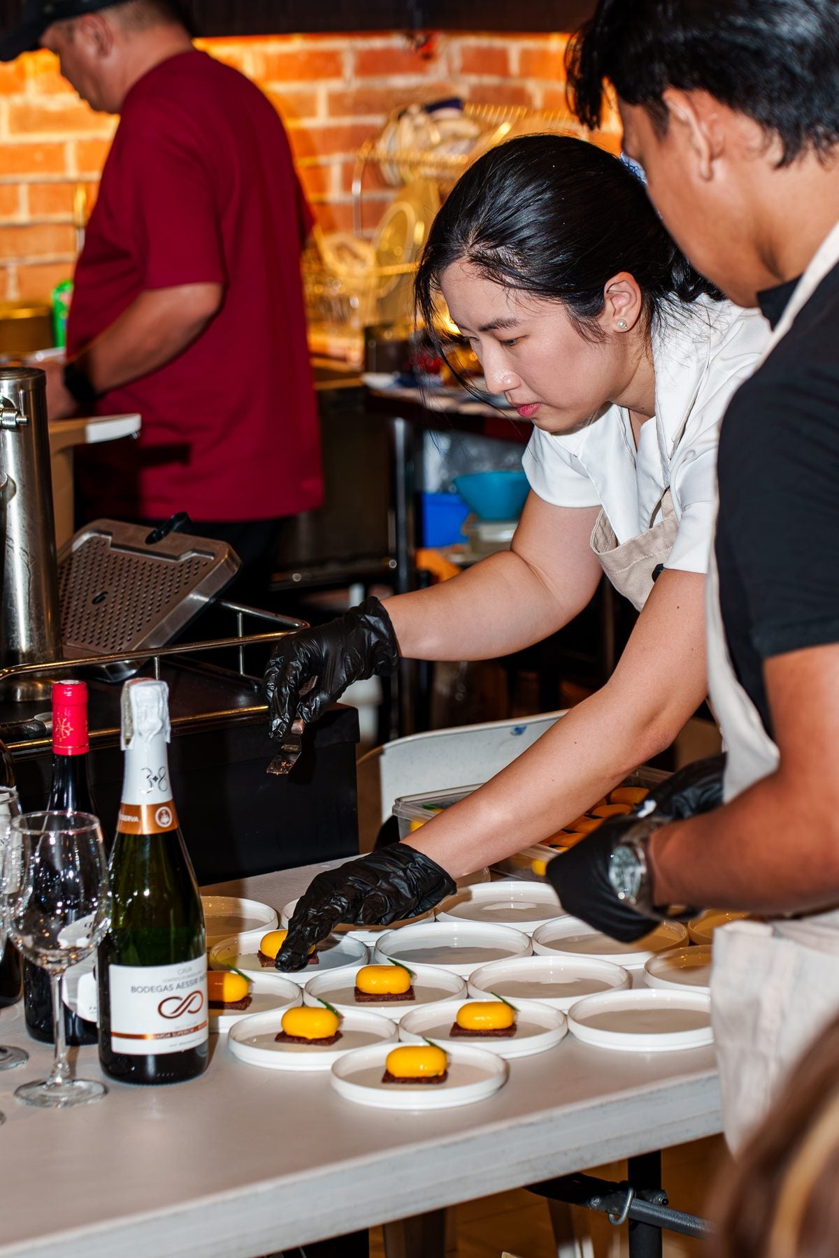 Indulge pastry chef plating desserts with wine